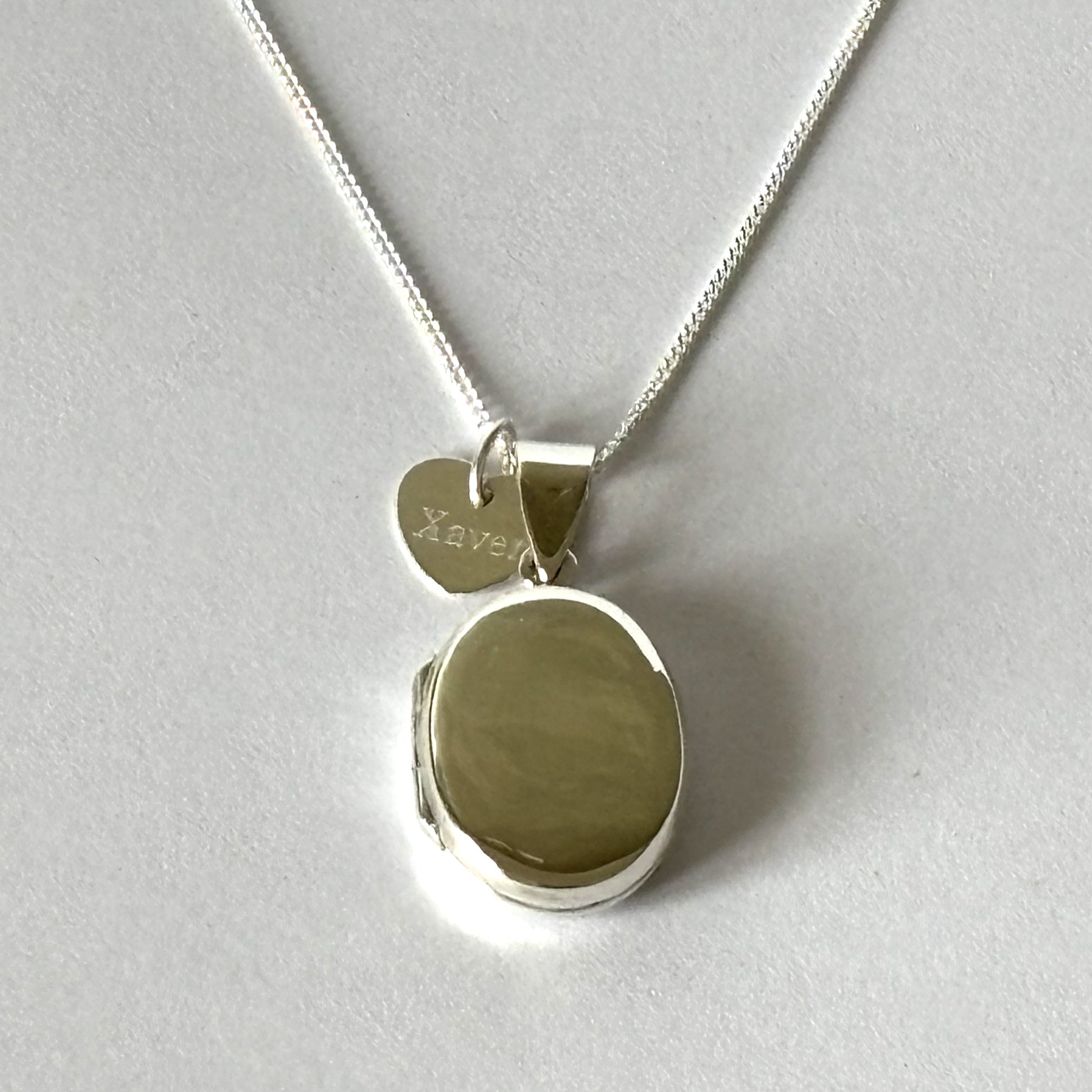 oval locket shown with heart engraved tag