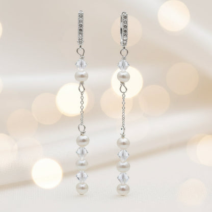 Pearl and crystal earrings using 4mm freshwater pearls and highest quality crystals (also 4mm). The earrings are suspended from sterling silver hoops studded with tiny crystals to reflect the light. 