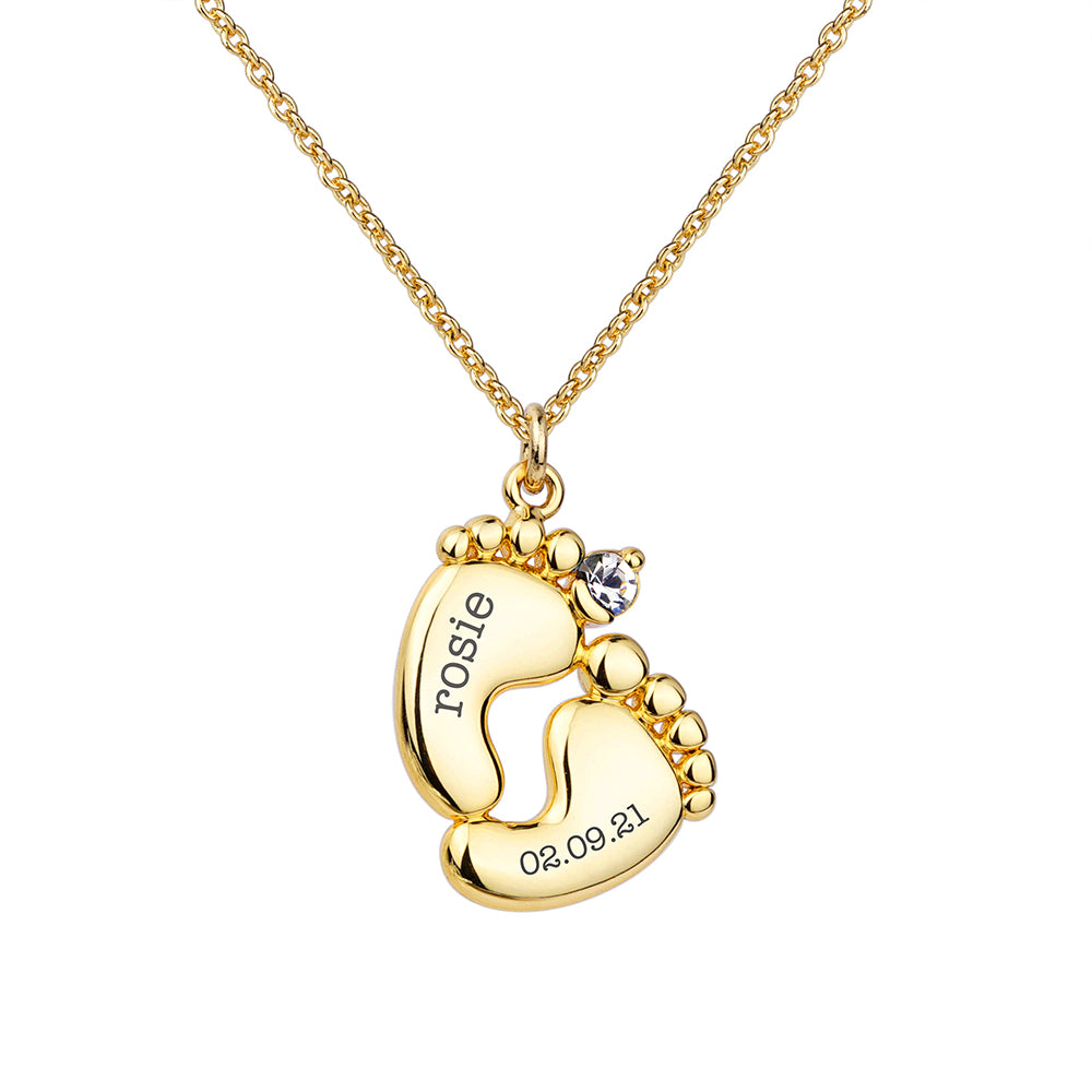 Personalised baby feet necklace. Engraved with baby’s name and date of birth on adjustable necklace. Shown in gold plate.