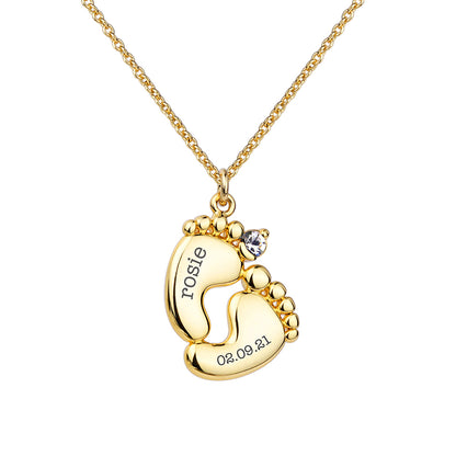 Personalised baby feet necklace. Engraved with baby’s name and date of birth on adjustable necklace. Shown in gold plate.