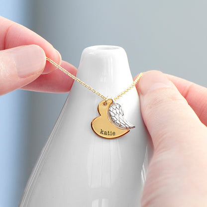 Gold plated angel wing charm is hung next to a partially formed silver plated heart. Together they complete the heart shape. Gold part of heart can be engraved with a name of your choice.