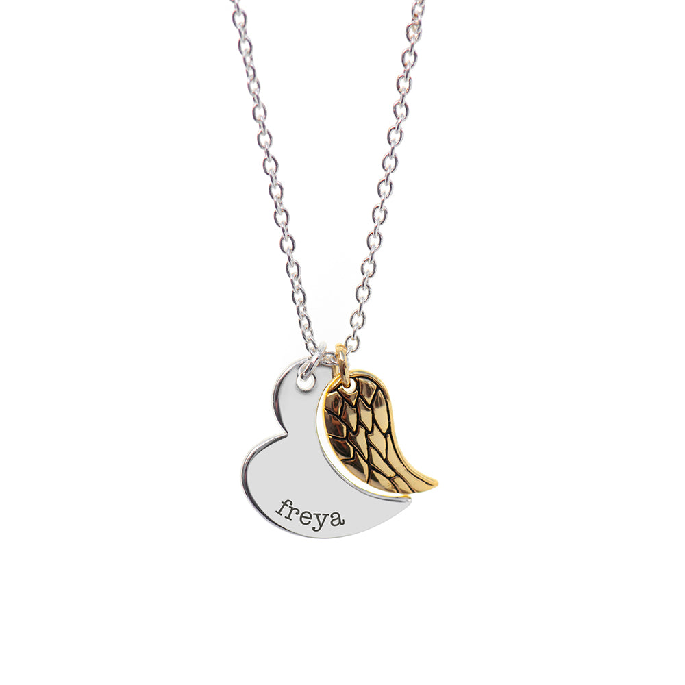 Gold plated angel wing charm is hung next to a partially formed silver plated heart. Together they complete the heart shape. Silver part of heart can be engraved with a name of your choice.