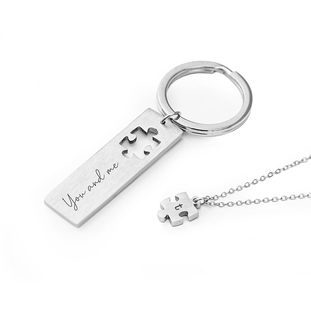 Perfect fit puzzle and keyring. The keyring has a missing jigsaw piece. The missing piece is on a pendant. Add a message to the keyring and an initial to the pendant.