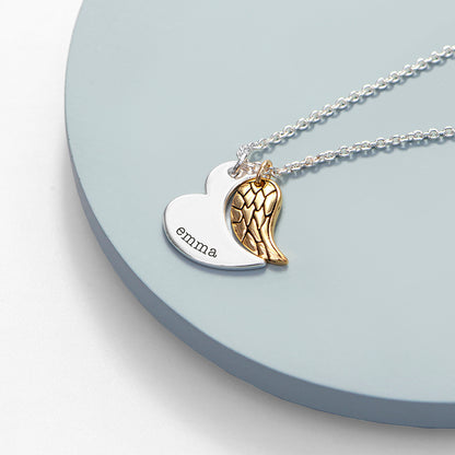 Gold plated angel wing charm is hung next to a partially formed silver plated heart. Together they complete the heart shape. Silver part of heart can be engraved with a name of your choice.