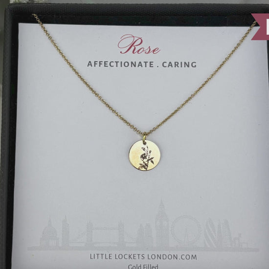 delicate Gold Filled Birth Flower Pendant. Crafted on an 11mm coin pendant, this simple piece is engraved with the intricate design of birth flowers on the front side and on the reverse side features a hidden personalised engraving, making it truly unique.