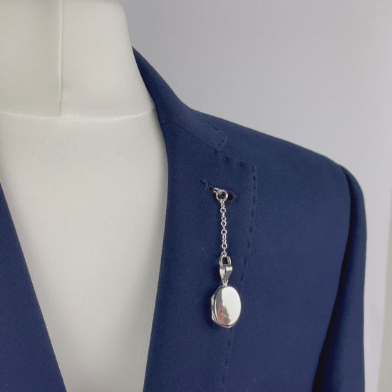 Sterling silver oval photo pocket locket shown with t bar fastening through buttonhole