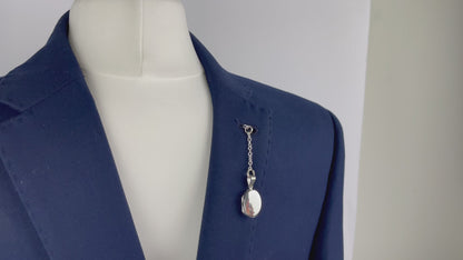 Sterling silver oval photo pocket locket shown with t bar fastening through buttonhole
