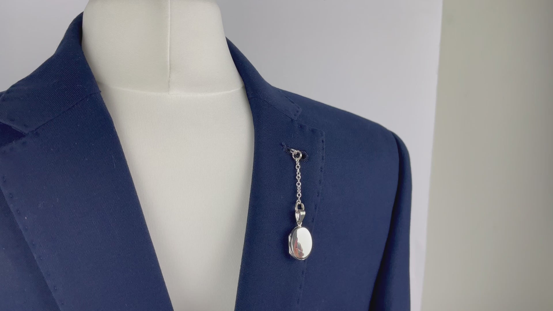 Sterling silver oval photo pocket locket shown with t bar fastening through buttonhole