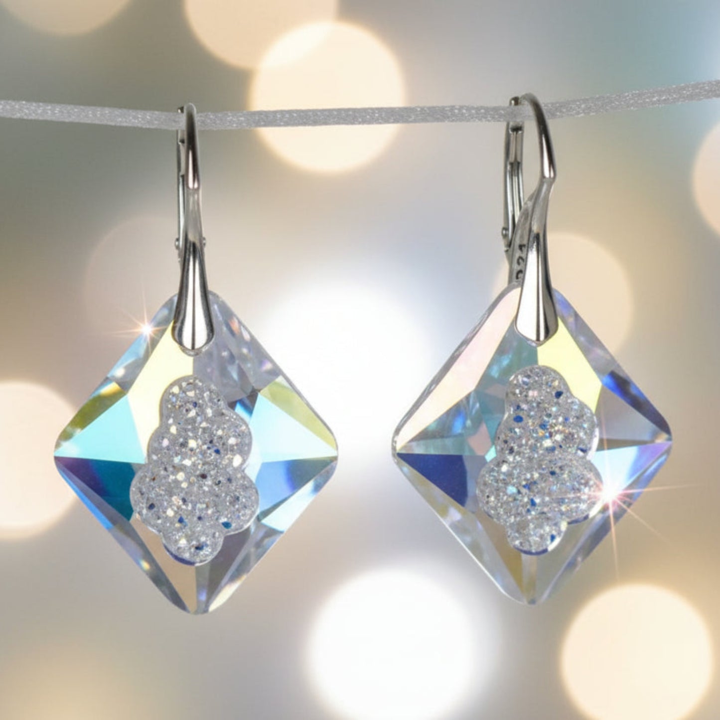 Highest quality crystal earrings with an uneven middle to give the appearance that they are a living crystal, still growing. They reflect light more than other crystals. Mounted on sterling silver lever-back earwires.