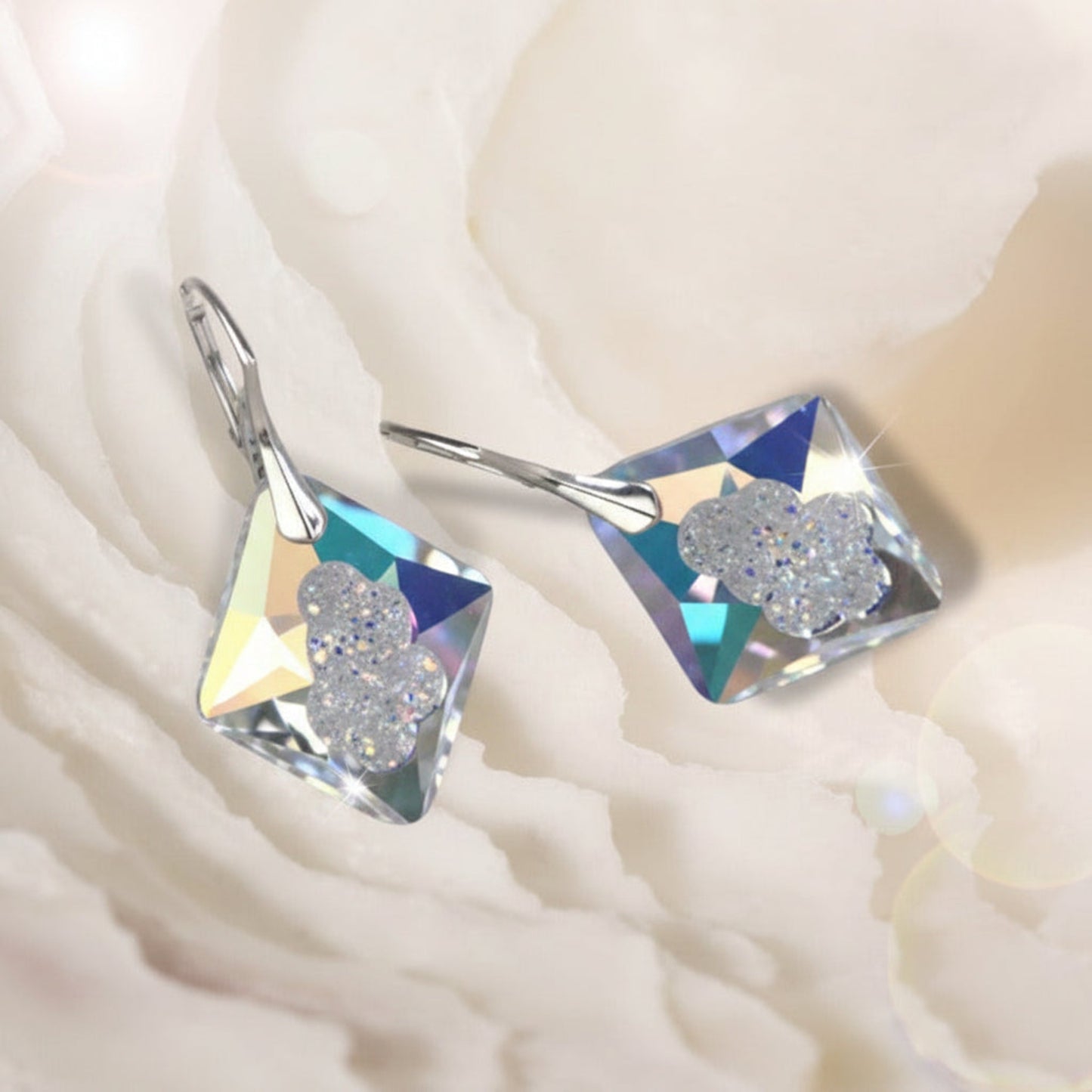 Highest quality crystal earrings with an uneven middle to give the appearance that they are a living crystal, still growing. They reflect light more than other crystals. Mounted on sterling silver lever-back earwires.