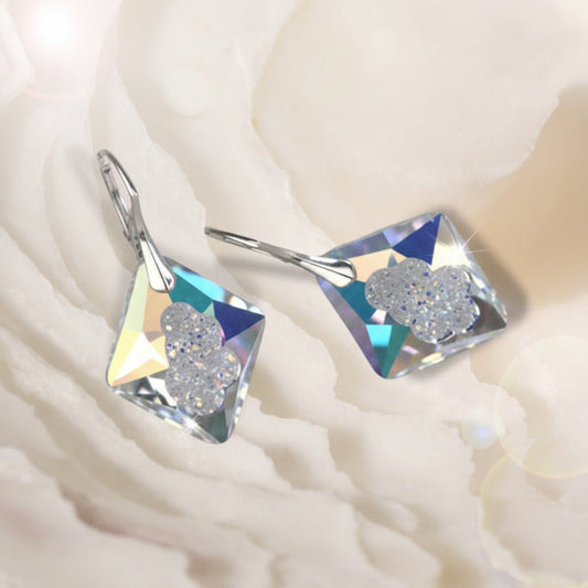Highest quality crystal earrings with an uneven middle to give the appearance that they are a living crystal, still growing. They reflect light more than other crystals. Mounted on sterling silver lever-back earwires.