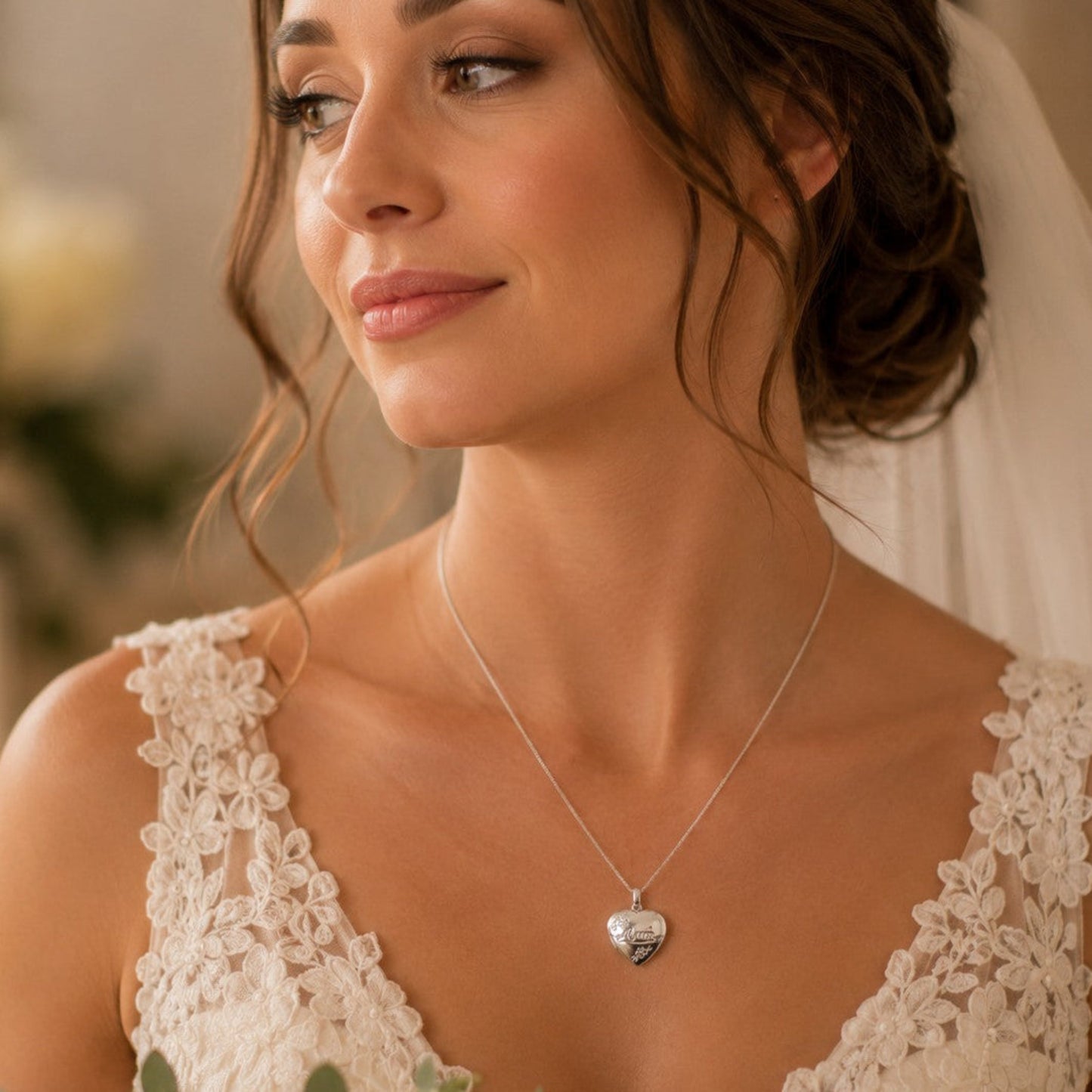 A bride wears a sterling silver locket engraved with the word "Mum" on her wedding day.