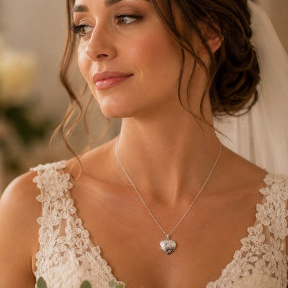 A bride wears a sterling silver locket engraved with the word "Mum" on her wedding day.