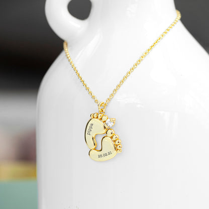 Gold plated baby feet pendant with crystal. One foot has baby's name and the other their birth date