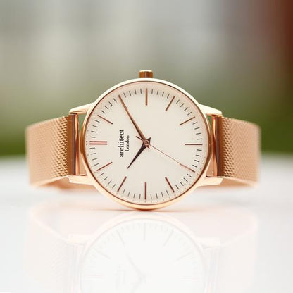 Large white dial with rose gold markers for numerals and rose gold mesh watch strap. Minute, hour and second hand. Architect Watches of London