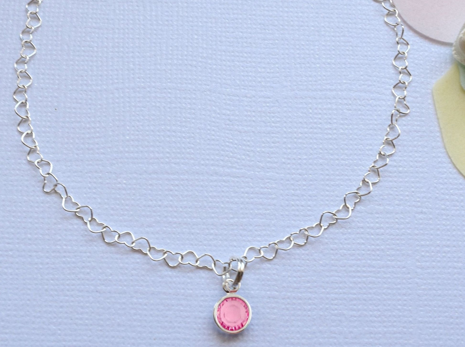 beautiful anklet with heart shaped lines and adorned with a single birthstone of your choice.  Sterling silver.