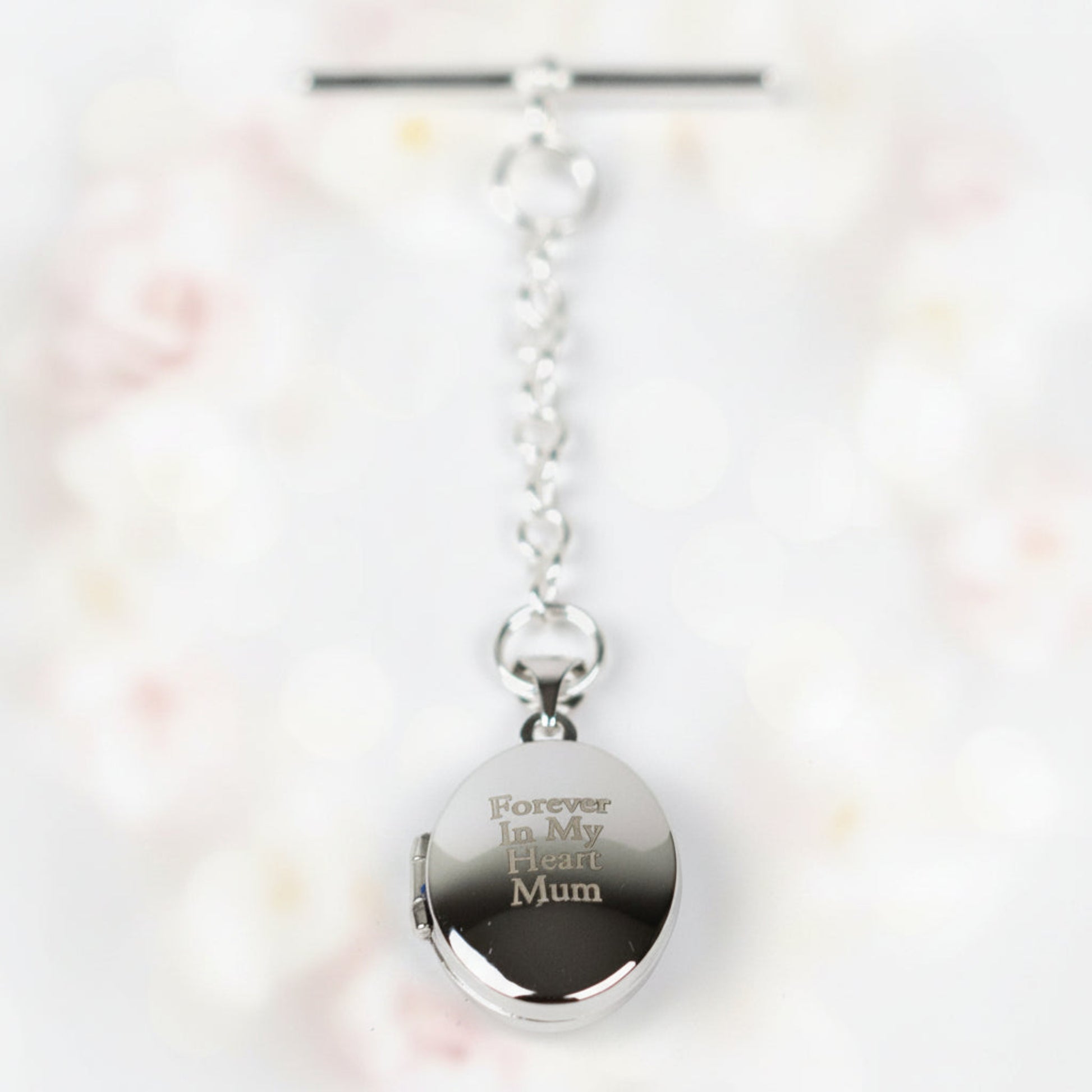 Sterling Silver Mens Engraved Photo Memorial Locket. Sterling silver elegant locket features a polished finish and offers the choice of a T-bar or spring clasp fastening. On gift card in gift box.